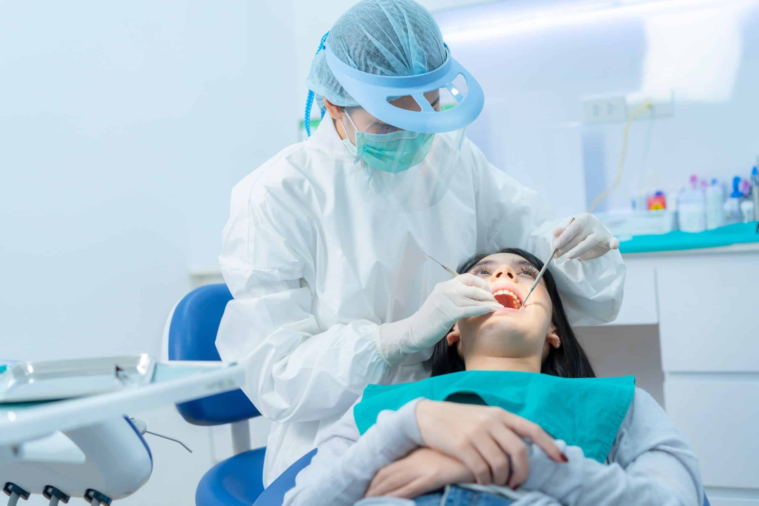 The woman is getting a regular dental checkups, and that will keep her away from tooth decay.