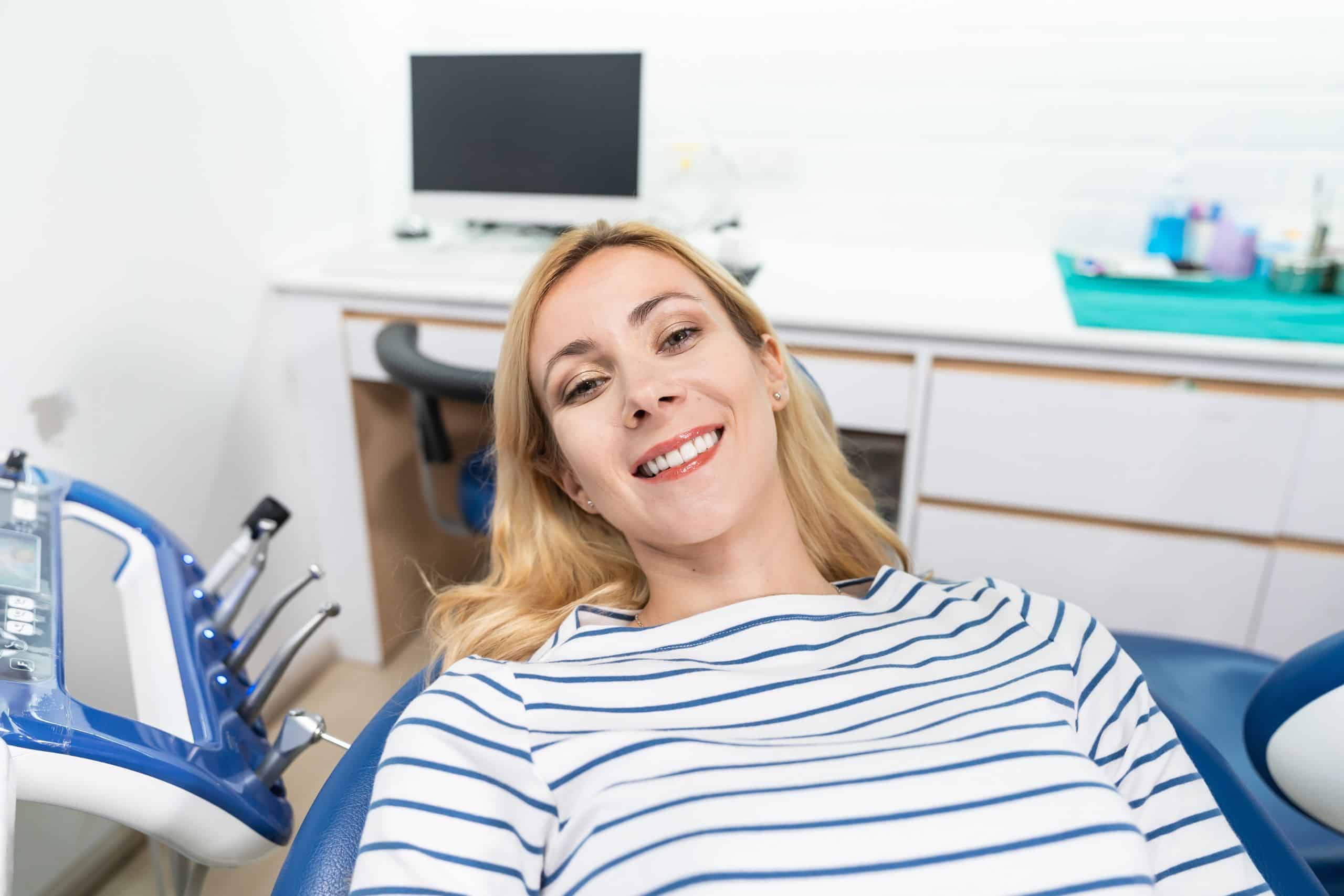 The woman is getting a cosmetic treatment to whiten her teeth before the holidays