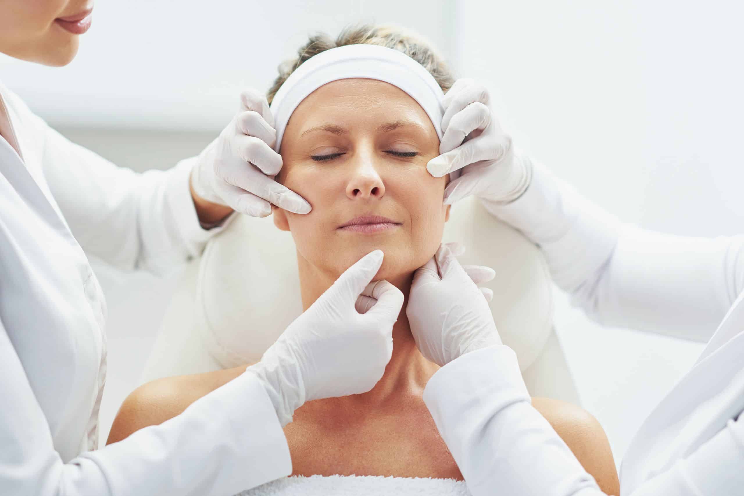 Dentist examining the face before botox treatment that will aid headache
