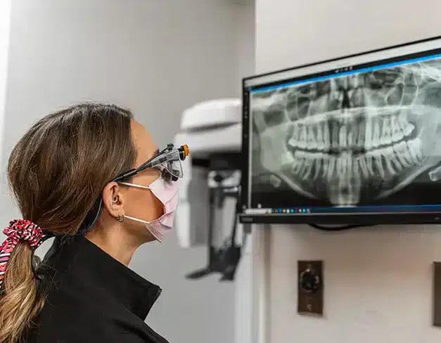 Dentist reviewing dental implant X-ray at Darley Dental Care