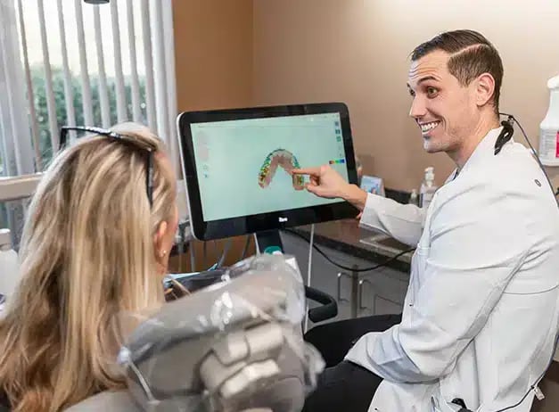 Dentist explaining about the crooked teeth fixing by invisaligners at Darley Dental Care